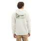 Person wearing a white hoodie with a logo on the back, standing against a white background
