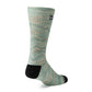 A single crew sock with a sage green and beige wavy pattern, featuring a solid black heel and toe, shown on a white background.