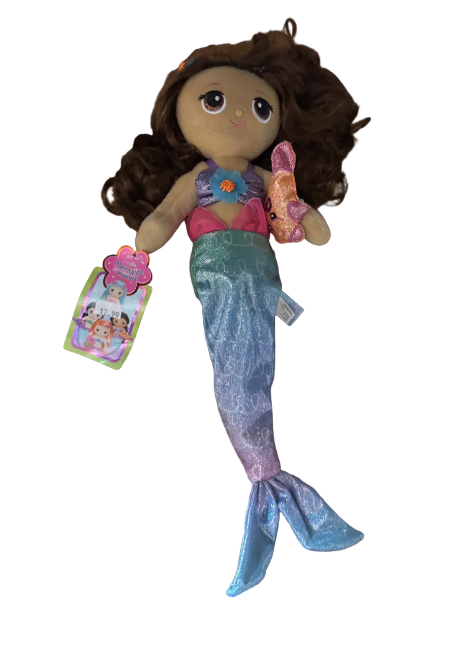 Mermaid doll with a tag on a brown surface
