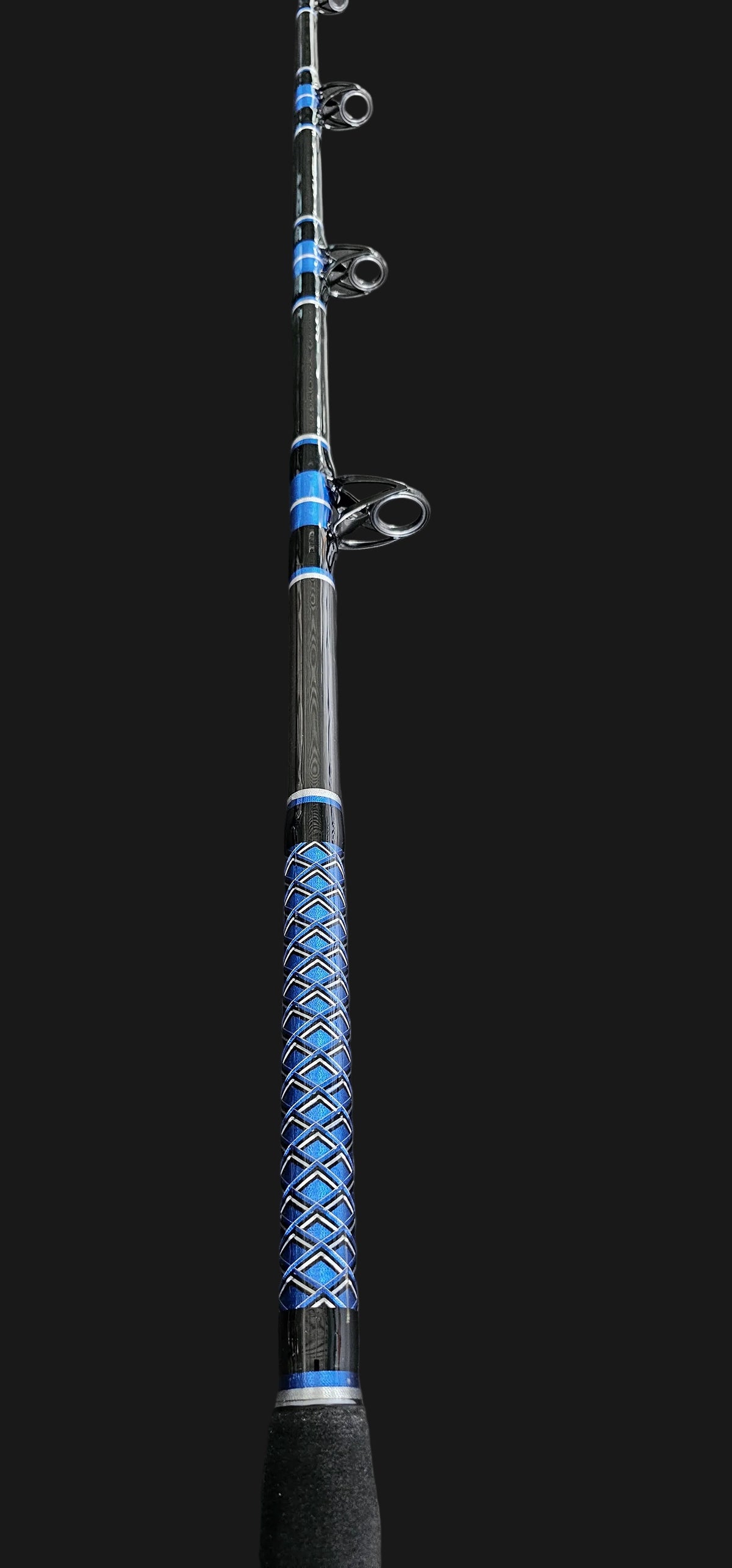 A black and blue Dogfish Stik fishing rod with a textured blue and black handle with an all background 