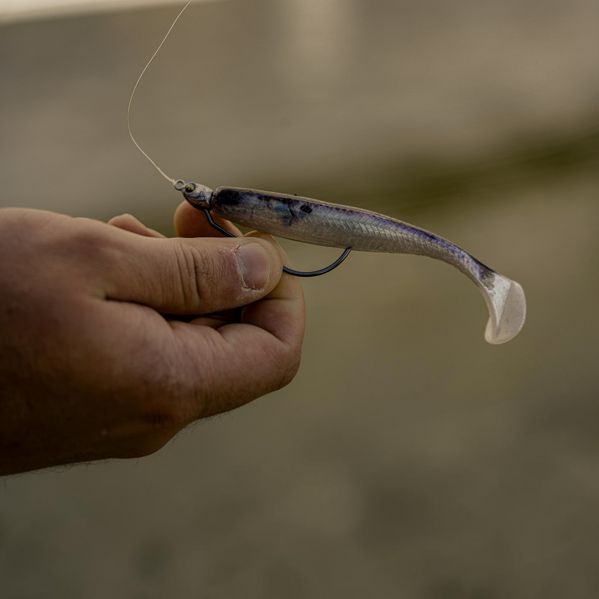 Dogfish Tackle & Marine 6th Sense Axle Swimbait Jig Head rigged with a translucent purple soft plastic swimbait