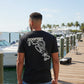Dogfish Tackle & Marine black poly-cotton t-shirt with Florida Unchained logo on back. Crew neck, short sleeves.