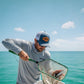 Dogfish Tackle & Marine blue and white trucker hat with leather tarpon patch, mesh back, and structured front panels.