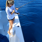 Woman fishing offshore on a boat with a Dogfish Stik 15H conventional rod, 7ft, 40-80lb line weight, EVA foam grip.