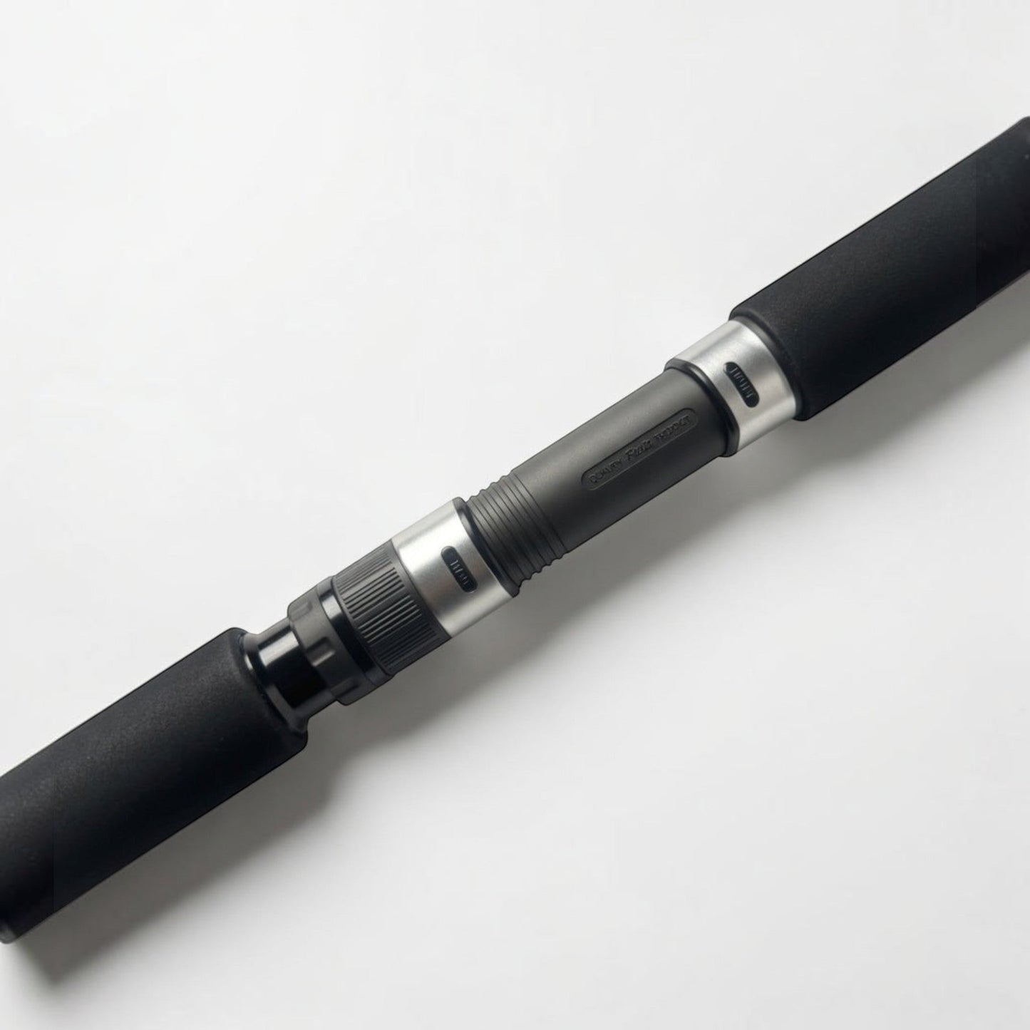Dogfish Tackle & Marine conventional fishing rod with black EVA foam grips and silver reel seat.