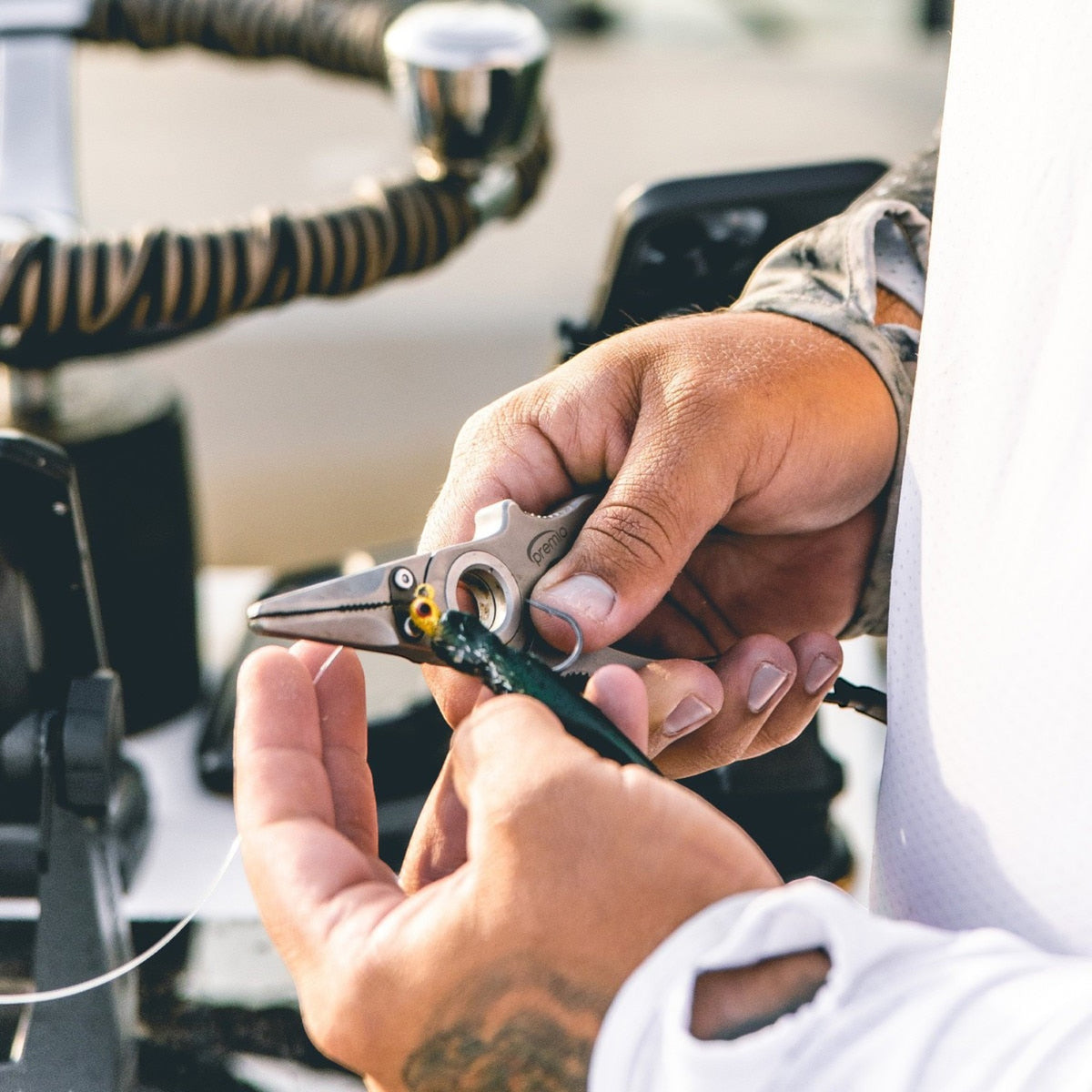 Dogfish Tackle & Marine Danco Premio titanium fishing pliers held by an angler removing a hook from a lure