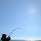 Dogfish Tackle & Marine angler using Seaguar Gold Label fluorocarbon leader on a fishing rod against a clear blue sky