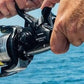 Dogfish Tackle & Marine Shimano Baitrunner OC 8000 saltwater spinning reel with yellow line, black graphite body, and aluminum handle.
