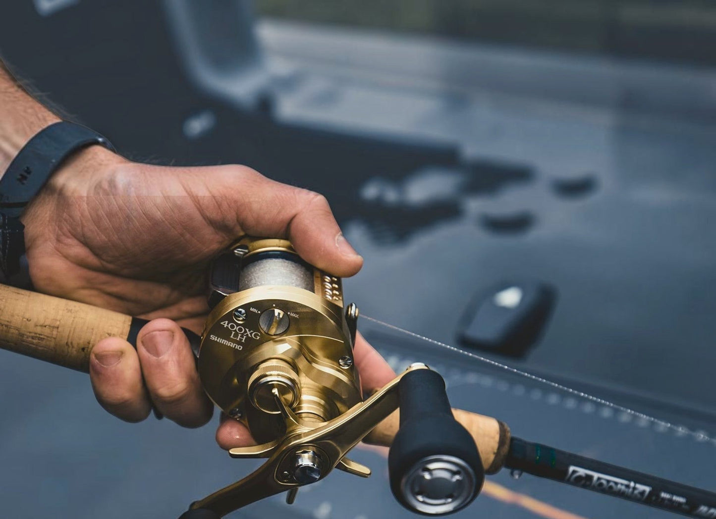 Dogfish Tackle & Marine Shimano Calcutta Conquest MD casting reel, gold finish, with cork handle and black grip.