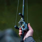 Dogfish Tackle & Marine Shimano Curado DC baitcasting reel in gunmetal grey with gold accents, held by a hand.