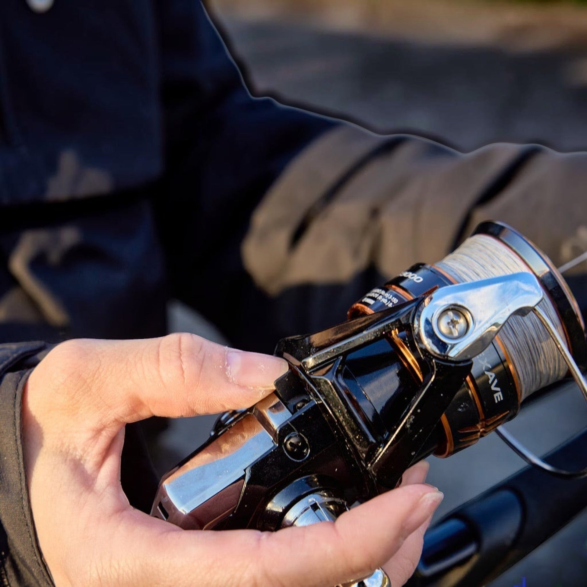 Dogfish Tackle & Marine Shimano Nexave FJ spinning reel with grey fishing line on spool. Black and silver body.