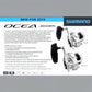 Shimano Ocea Jigger star drag conventional fishing reels in silver and black, featuring a long adjustable handle and compact aluminum frame.