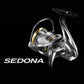 Dogfish Tackle & Marine Shimano Sedona FJ spinning reel in silver and gold, featuring HAGANE Gear and SilentDrive technology.