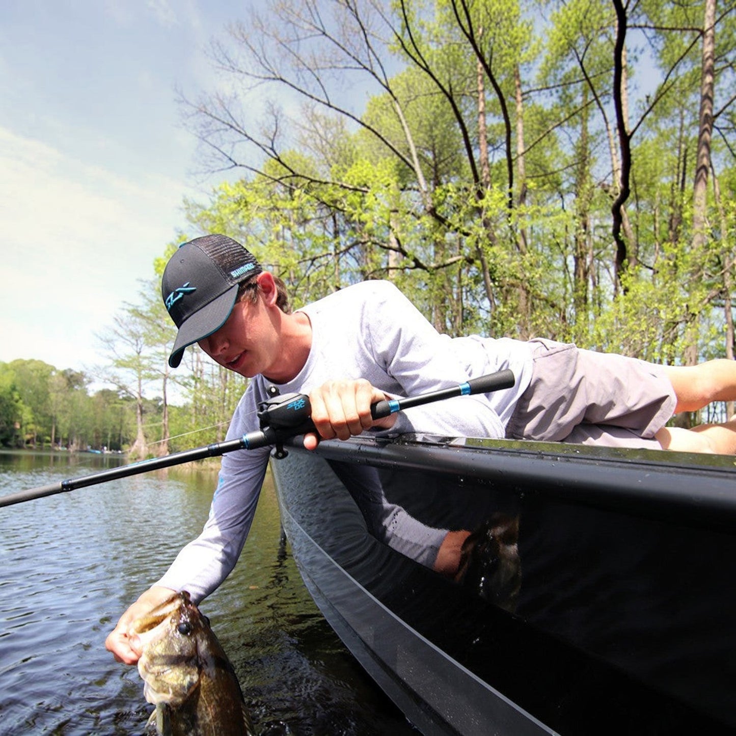 Dogfish Tackle & Marine Shimano SLX DC low profile baitcasting reel with a man holding a fish on a boat.