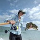 Woman holding a caught fish with a Shimano Spheros SW spinning reel and fishing rod, Dogfish Tackle & Marine