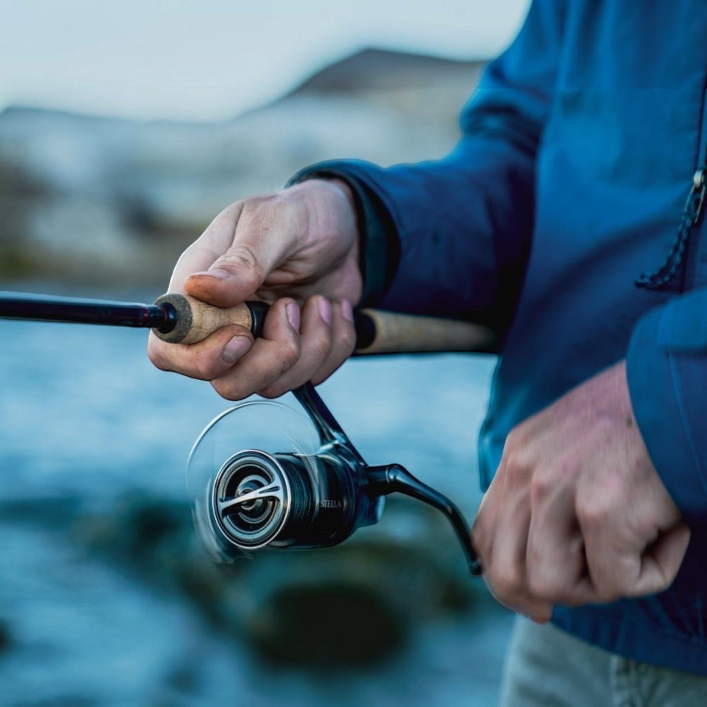 Dogfish Tackle & Marine Shimano Stella FK spinning reel with cork handle, dark metallic body, and silver spool.