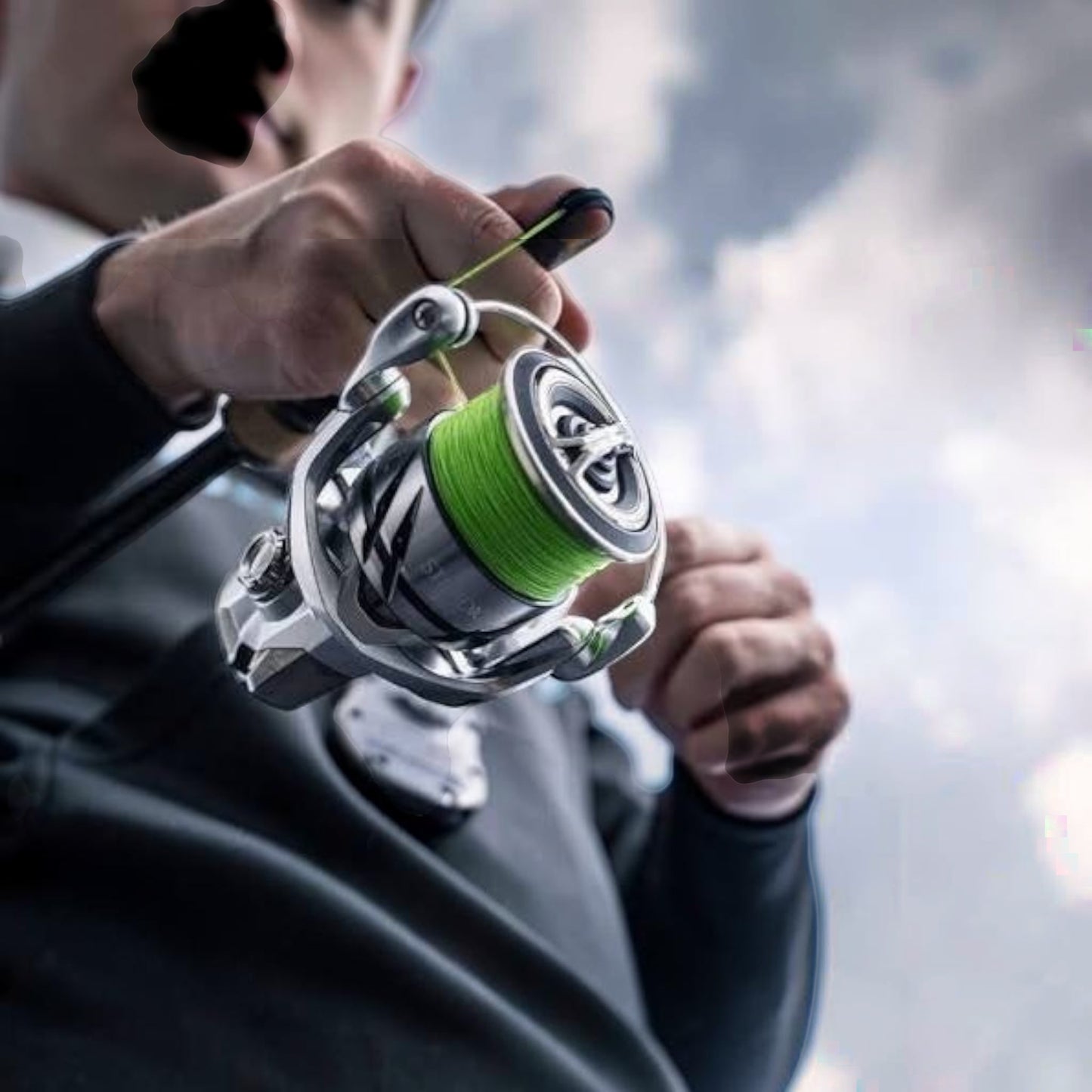 Dogfish Tackle & Marine Shimano Stradic FM spinning reel with bright green fishing line, silver body, and black accents.