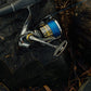 Dogfish Tackle & Marine Shimano Sustain FK spinning reel with blue fishing line, silver and black body, gold accents.