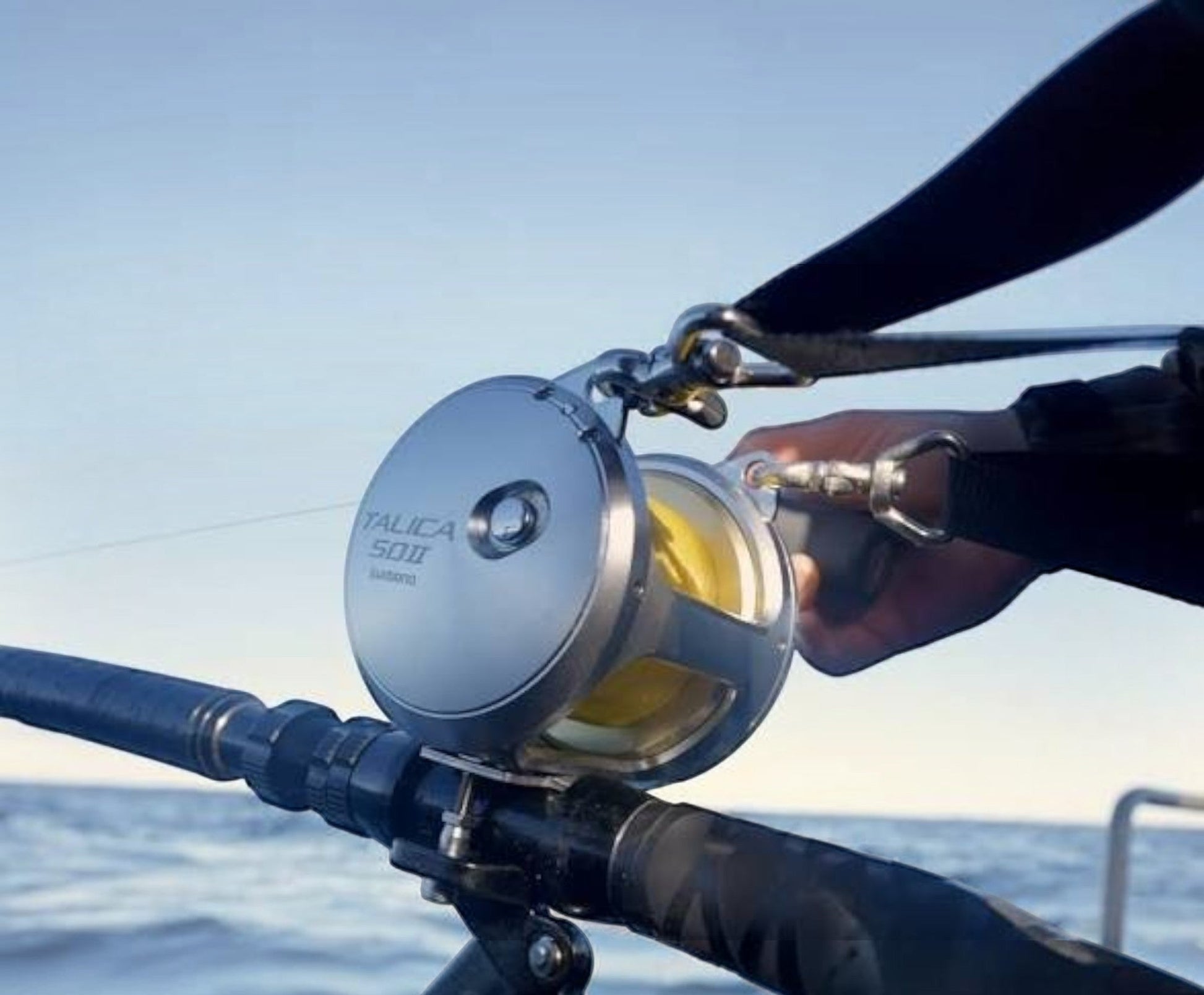Dogfish Tackle & Marine Shimano Talica 50II A 2-speed lever drag fishing reel with yellow line on a fishing rod.
