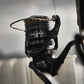 Dogfish Tackle & Marine Shimano Twin Power XD FB spinning reel, black, with multi-colored fishing line and water droplets.
