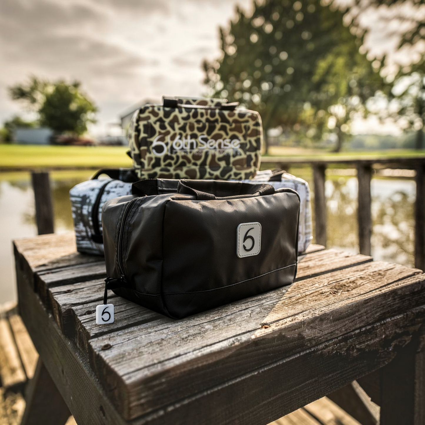 Dogfish Tackle & Marine 6th Sense small black bait bag for soft plastics on a wooden dock by the water